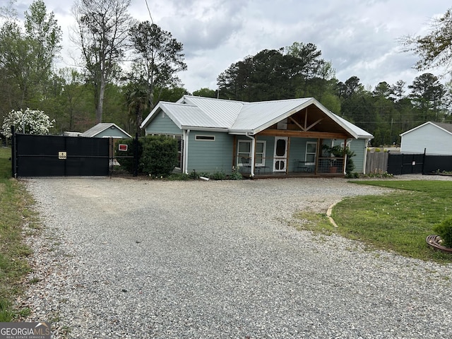 6121 N Main St SE, Acworth, GA 30101 - view of front of property with a porch, fence, driveway, and metal roof