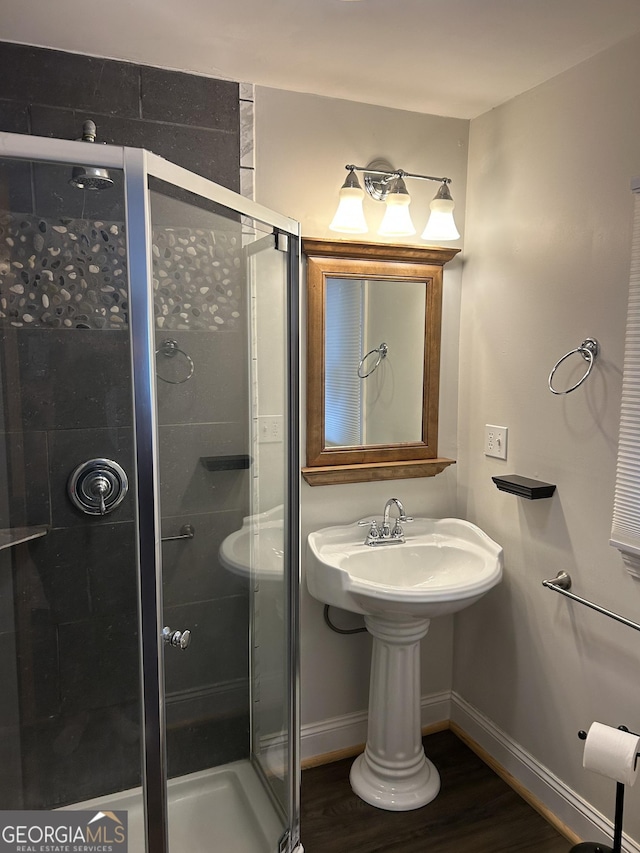 6121 N Main St SE, Acworth, GA 30101 - bathroom with baseboards, a shower stall, and wood finished floors