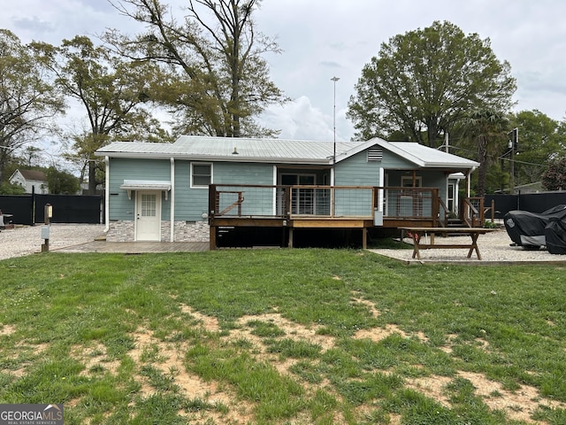 6121 N Main St SE, Acworth, GA 30101 - rear view of house with stone siding, fence, a yard, and a deck