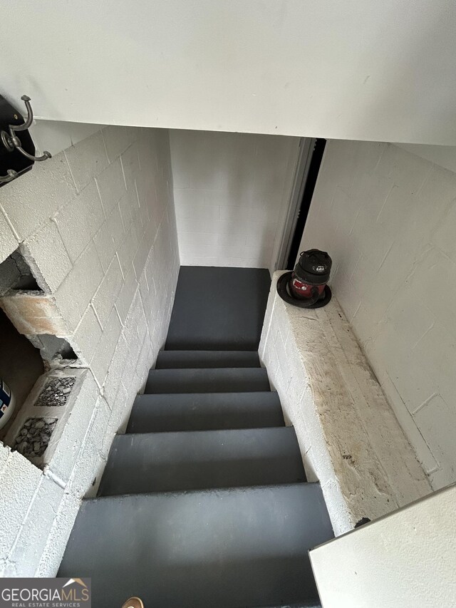 6121 N Main St SE, Acworth, GA 30101 - staircase featuring concrete block wall