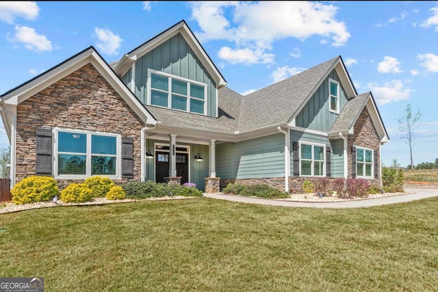 1030 Open Water Dr, Greensboro, GA 30642 - craftsman house with stone siding, board and batten siding, a front lawn, and roof with shingles