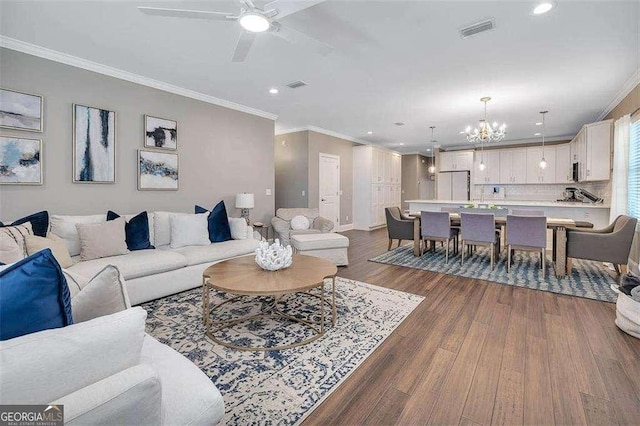 123 E Commons Dr, Saint Simons, GA 31522 - living room featuring a chandelier, crown molding, dark wood-type flooring, recessed lighting, and a ceiling fan