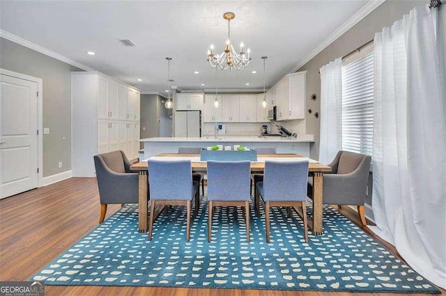 123 E Commons Dr, Saint Simons, GA 31522 - dining room with a chandelier, crown molding, wood finished floors, and recessed lighting