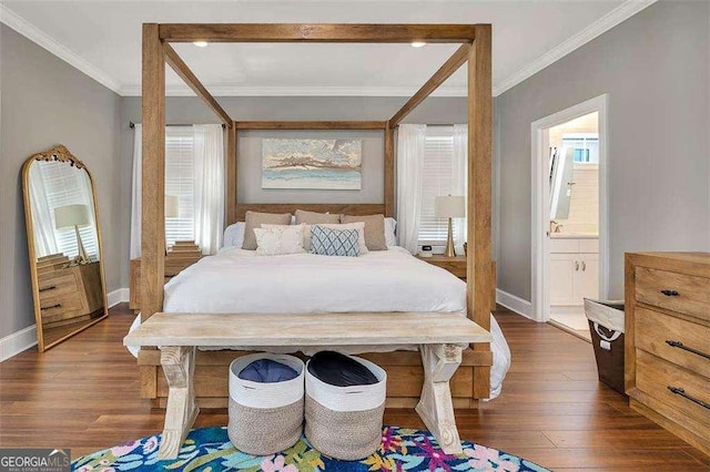 123 E Commons Dr, Saint Simons, GA 31522 - bedroom featuring crown molding, dark wood-style floors, multiple windows, and ensuite bathroom