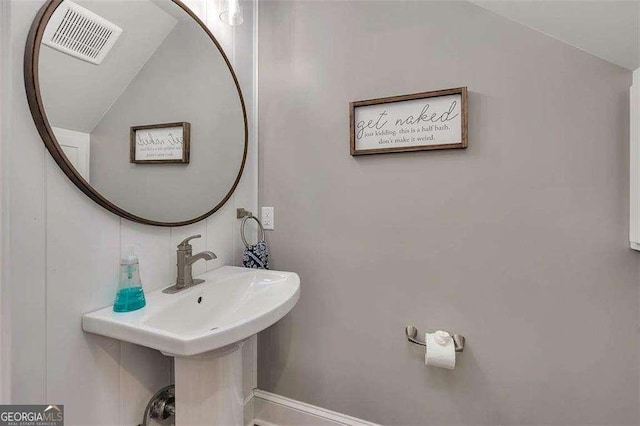 123 E Commons Dr, Saint Simons, GA 31522 - bathroom featuring lofted ceiling and a sink