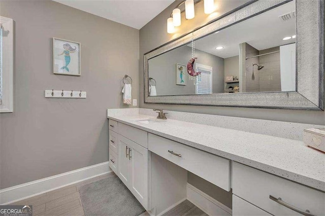 123 E Commons Dr, Saint Simons, GA 31522 - bathroom featuring vanity and tiled shower