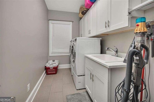 123 E Commons Dr, Saint Simons, GA 31522 - washroom with separate washer and dryer, cabinet space, and light tile patterned flooring
