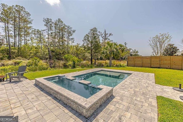 123 E Commons Dr, Saint Simons, GA 31522 - view of swimming pool featuring a patio and a pool with connected hot tub