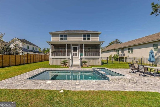 123 E Commons Dr, Saint Simons, GA 31522 - rear view of house featuring a sunroom, a fenced backyard, a patio area, and a pool with connected hot tub
