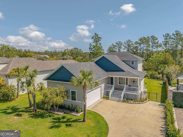 123 E Commons Dr, Saint Simons, GA 31522 - view of front facade featuring a porch, concrete driveway, and a garage