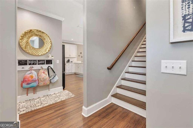 123 E Commons Dr, Saint Simons, GA 31522 - staircase with wood finished floors and ornamental molding