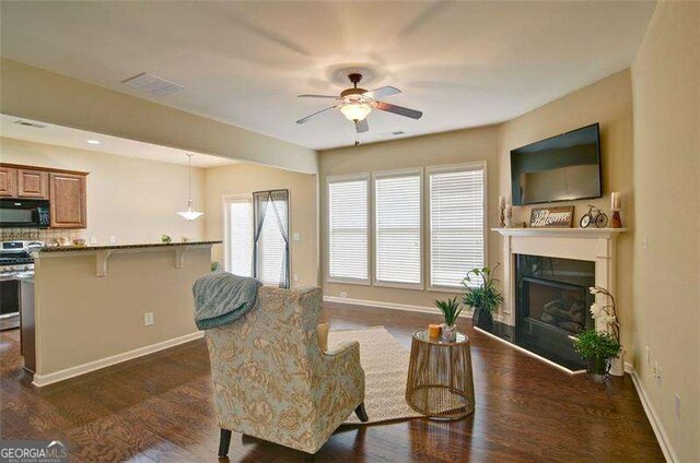 4854 Allston Ln, Peachtree Corners, GA 30092 - living room featuring plenty of natural light, dark wood-style floors, a glass covered fireplace, and a ceiling fan