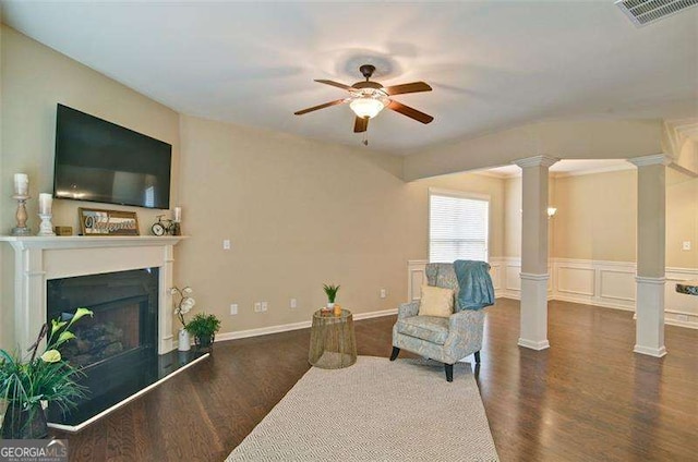4854 Allston Ln, Peachtree Corners, GA 30092 - sitting room featuring decorative columns, a fireplace with raised hearth, wood finished floors, visible vents, and ceiling fan