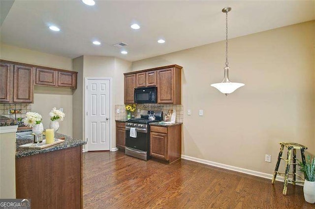 4854 Allston Ln, Peachtree Corners, GA 30092 - kitchen with baseboards, tasteful backsplash, dark wood finished floors, stainless steel gas range oven, and black microwave