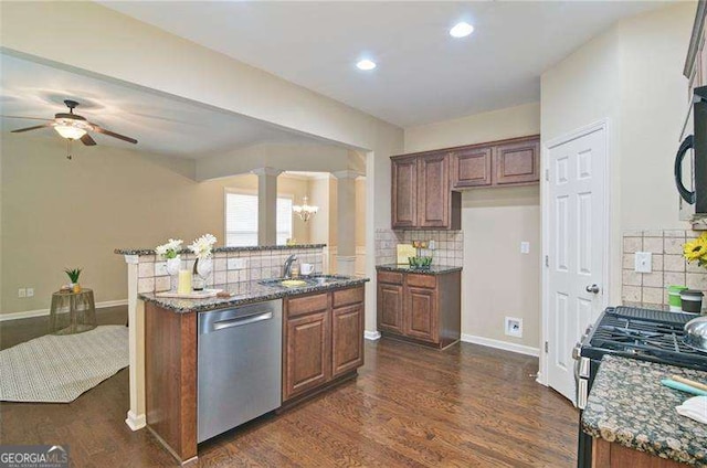 4854 Allston Ln, Peachtree Corners, GA 30092 - kitchen with dark wood-style flooring, dark stone counters, stainless steel appliances, and a ceiling fan