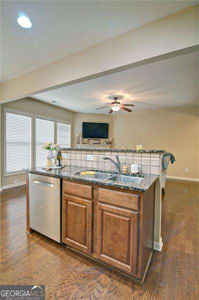 4854 Allston Ln, Peachtree Corners, GA 30092 - kitchen featuring a center island, a sink, dark stone countertops, and dishwasher