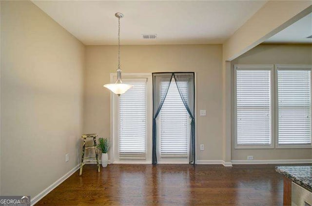 4854 Allston Ln, Peachtree Corners, GA 30092 - unfurnished dining area featuring wood finished floors, baseboards, and visible vents