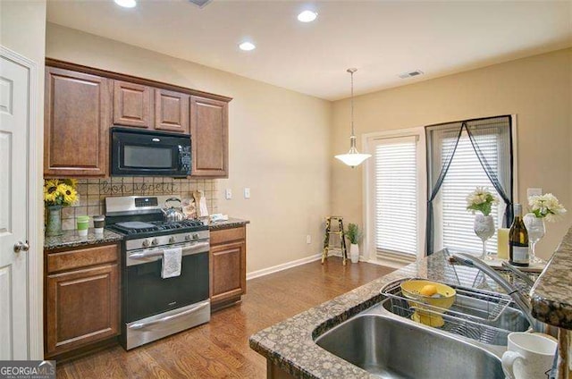 4854 Allston Ln, Peachtree Corners, GA 30092 - kitchen featuring visible vents, stainless steel gas range, dark wood-type flooring, black microwave, and backsplash