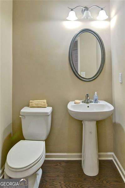 4854 Allston Ln, Peachtree Corners, GA 30092 - half bath with baseboards, toilet, and wood finished floors