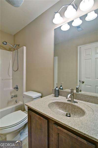 4854 Allston Ln, Peachtree Corners, GA 30092 - bathroom featuring toilet, vanity, and shower / bathtub combination