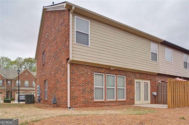 4854 Allston Ln, Peachtree Corners, GA 30092 - rear view of property with a lawn, fence, brick siding, and central AC