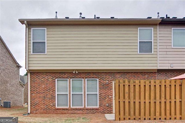 4854 Allston Ln, Peachtree Corners, GA 30092 - rear view of property featuring central AC unit, fence, and brick siding