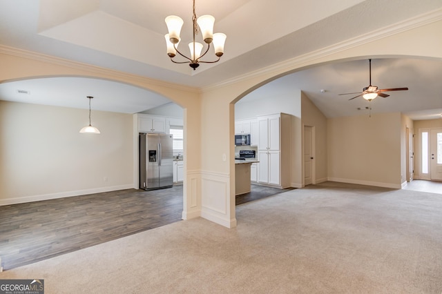 174 Livingston Ct, Winder, GA 30680 - unfurnished living room with carpet flooring, arched walkways, a chandelier, ceiling fan, and lofted ceiling