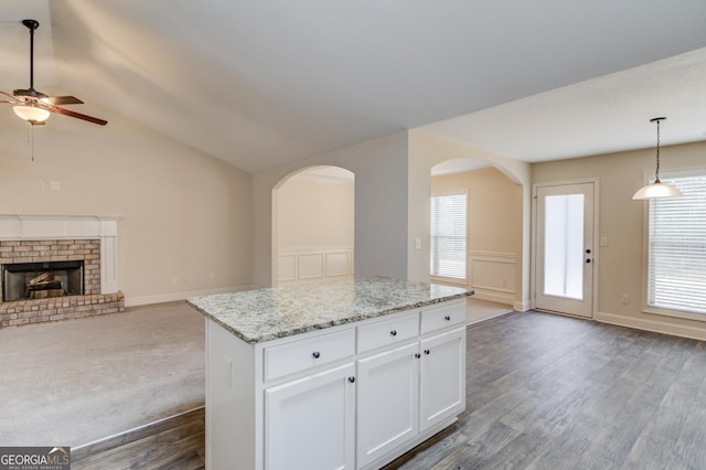 174 Livingston Ct, Winder, GA 30680 - kitchen with open floor plan, a ceiling fan, light stone counters, dark wood finished floors, and pendant lighting