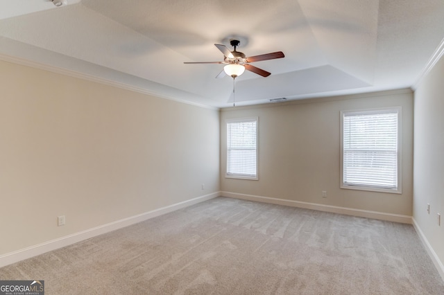174 Livingston Ct, Winder, GA 30680 - empty room with a tray ceiling, ceiling fan, crown molding, and light carpet