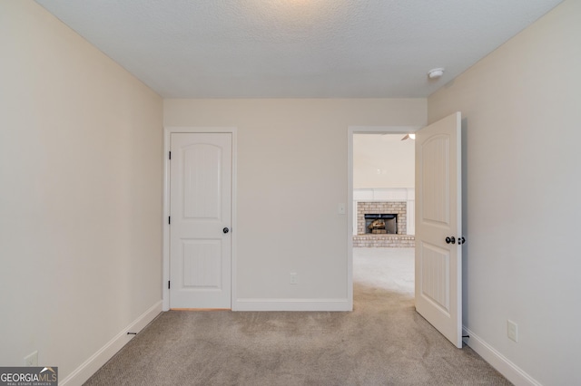 174 Livingston Ct, Winder, GA 30680 - spare room featuring light colored carpet, a smoke detector, and a fireplace