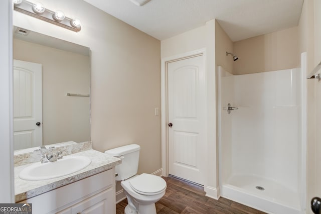 174 Livingston Ct, Winder, GA 30680 - bathroom featuring wood finished floors, vanity, and a shower