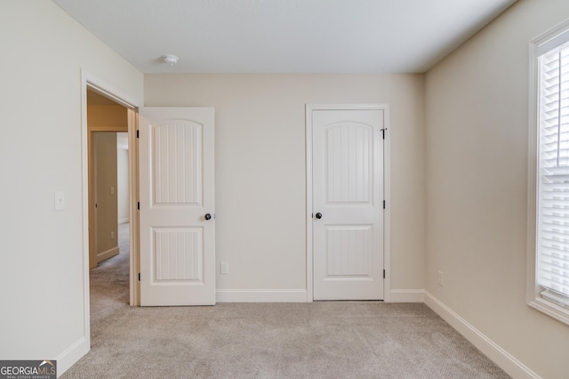 174 Livingston Ct, Winder, GA 30680 - unfurnished bedroom featuring light colored carpet and multiple windows