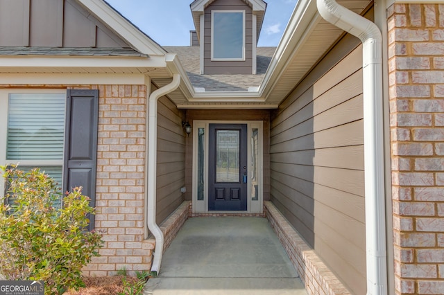 174 Livingston Ct, Winder, GA 30680 - property entrance with roof with shingles and brick siding