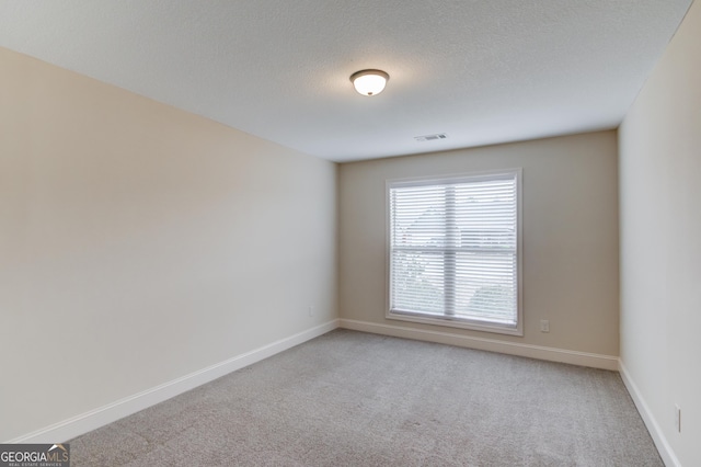 174 Livingston Ct, Winder, GA 30680 - spare room featuring light colored carpet and a textured ceiling