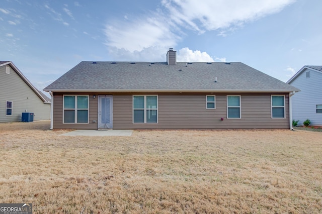 174 Livingston Ct, Winder, GA 30680 - back of property featuring a patio, a chimney, a lawn, and a shingled roof