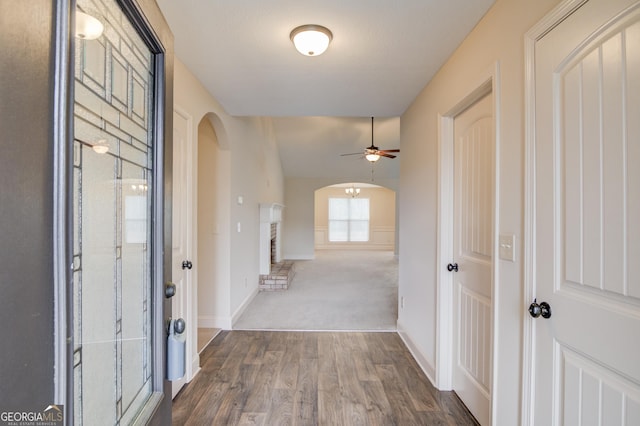 174 Livingston Ct, Winder, GA 30680 - hallway featuring arched walkways and dark wood-style flooring