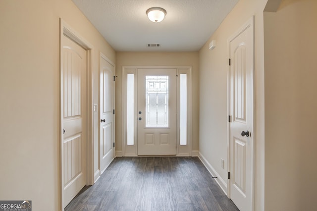 174 Livingston Ct, Winder, GA 30680 - foyer entrance featuring dark wood finished floors and baseboards