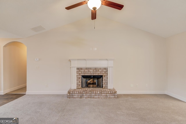 174 Livingston Ct, Winder, GA 30680 - unfurnished living room with a ceiling fan, carpet floors, a brick fireplace, arched walkways, and high vaulted ceiling
