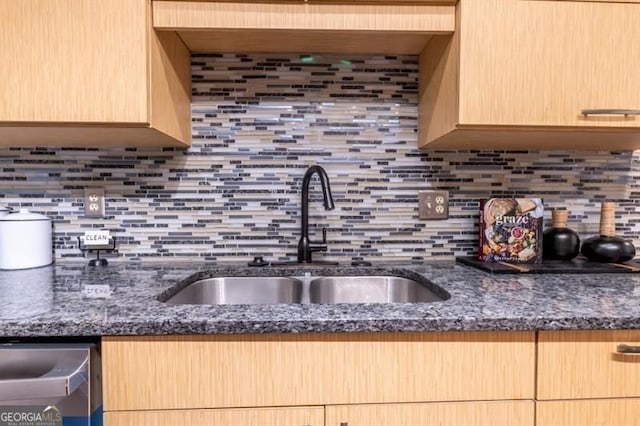 6851 Roswell Rd Unit A-12, Atlanta, GA 30328 - kitchen with a sink, decorative backsplash, light brown cabinets, stainless steel dishwasher, and dark stone counters