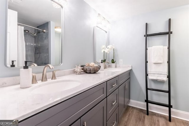 6851 Roswell Rd Unit A-12, Atlanta, GA 30328 - full bath with double vanity, wood finished floors, a shower with curtain, and baseboards