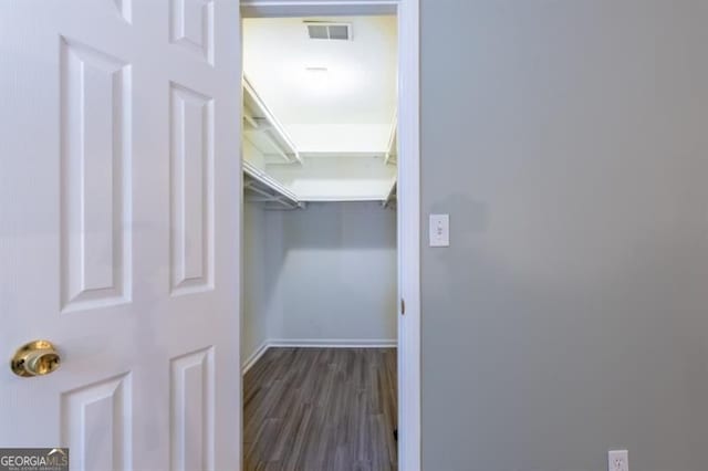 6851 Roswell Rd Unit A-12, Atlanta, GA 30328 - walk in closet with dark wood-style flooring