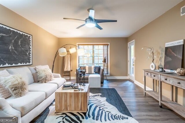 6851 Roswell Rd Unit A-12, Atlanta, GA 30328 - living room featuring wood finished floors, a ceiling fan, and baseboards