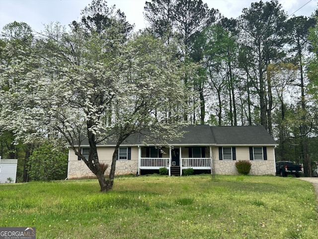 ranch-style house with a front lawn, covered porch, and stone siding