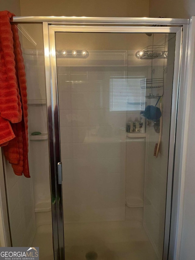 full bath with a shower stall