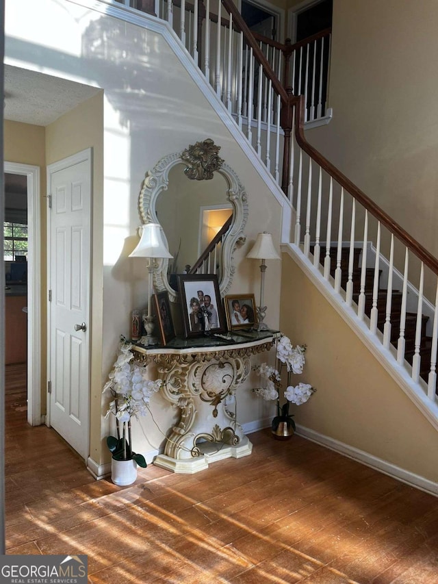 stairway featuring baseboards and wood finished floors