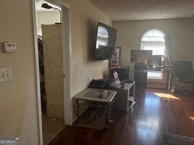 interior space featuring a textured ceiling and wood-type flooring