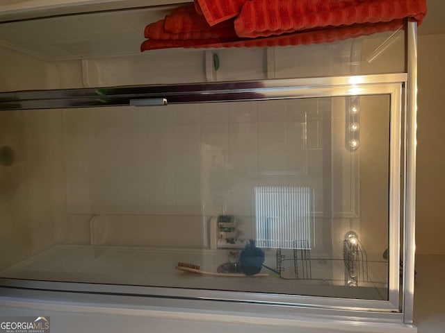 bathroom with a shower with door