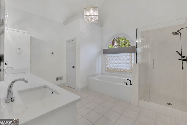 full bath featuring a sink, a stall shower, a garden tub, and visible vents