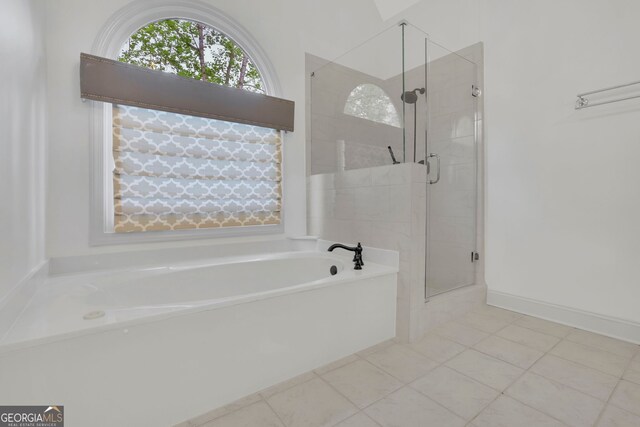 full bathroom featuring tile patterned floors, a garden tub, and a shower stall