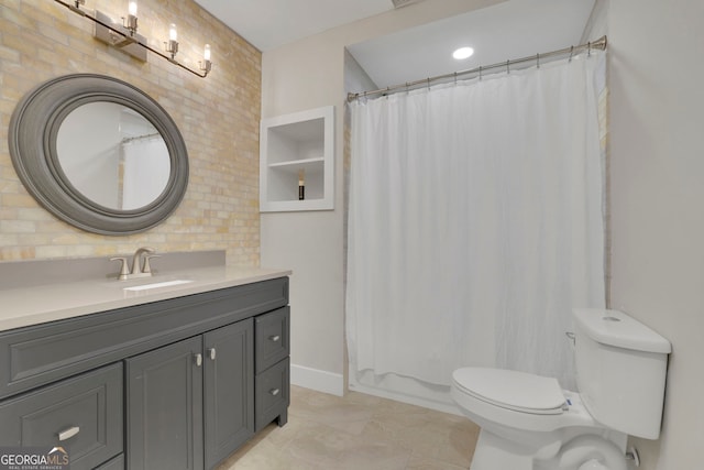 bathroom featuring toilet, vanity, and curtained shower